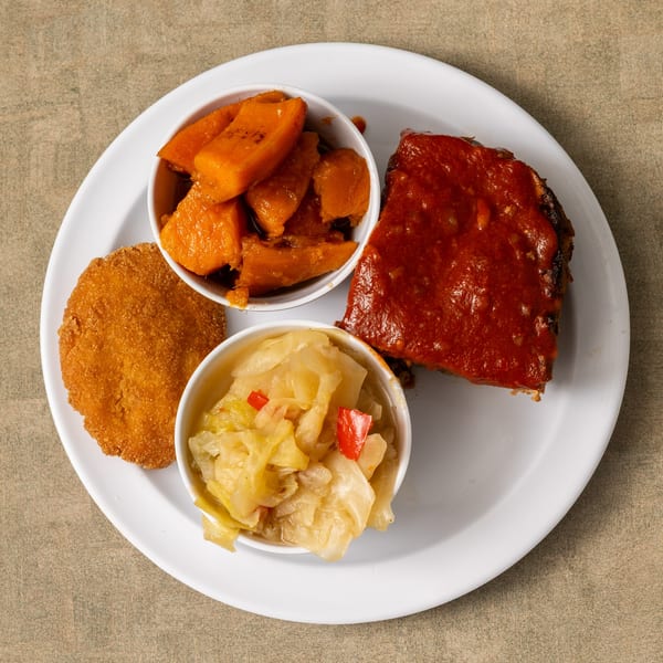 IDA MAE’S soul-food plate with meatloaf, candied yams, fried green tomato, and cabbage.