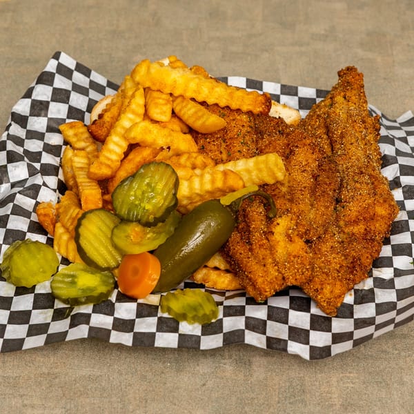 IDA MAE’S fried catfish and crinkle-cut fries, served with pickles and a jalapeño.