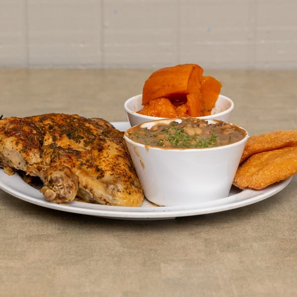 IDA MAE’S soul-food plate with roasted chicken, baked beans, candied yams, and cornbread.